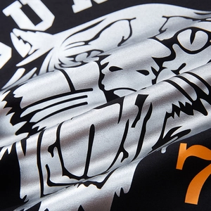 Men's black t-shirt with silver tiger head print and orange number 7 graphic detail
