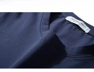 Detail of the navy blue crew neck collar with 3XL label and reinforced stitching