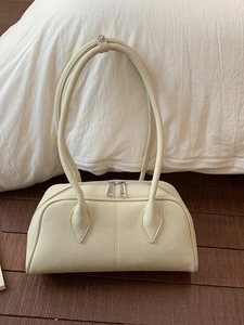 Elegant cream rectangular Boston bag with litchi grain texture and silver zippers