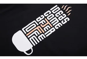 Detailed close-up of a coffee cup print with creative text on a black cotton long sleeve t-shirt