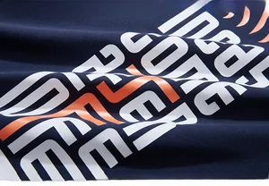 Detail of navy blue cotton fabric with high-quality white and orange letter printing
