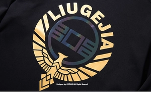 Detailed close-up of golden eagle emblem and iridescent logo on black long sleeve t-shirt