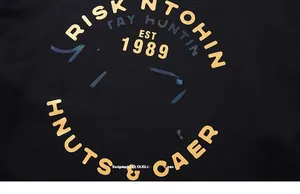 Detail des Huntclub-Gold- und Irise-Foliendrucks auf einem schwarzen Herren-Baumwoll-T-Shirt