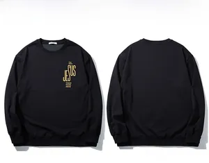 Detailed flat lay of black crewneck sweatshirt featuring gold Jesus letter print