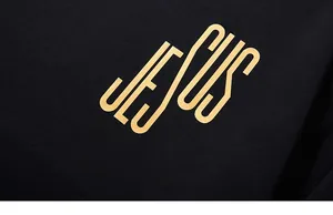 Macro detail of the golden Jesus artistic lettering print on a black premium sweatshirt