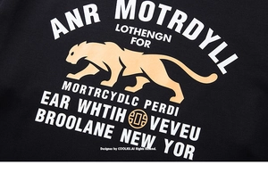 Close-up of golden leopard print and vintage letters on black cotton t-shirt