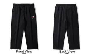 Detail view of black drawstring sweatpants with embroidered logo and back pocket design