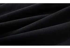 Close-up of thick black knitted fabric showing premium soft texture and weave detail