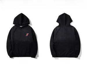 Front and back view of a black oversized street hoodie with red logo embroidery