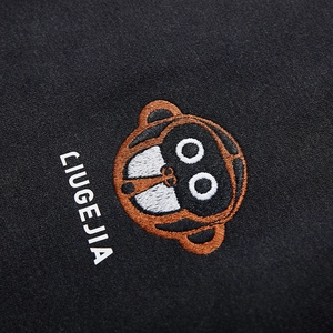 Close-up of raglan hoodie featuring monkey embroidery and CIUGEJIA print detailing