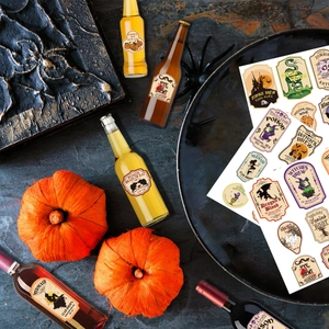 Vintage Halloween bottle labels with spooky designs for horror party table decorations
