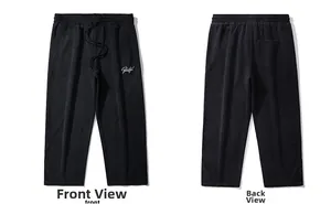 Front and back view of black drawstring track pants with Beautiful embroidery and paneling