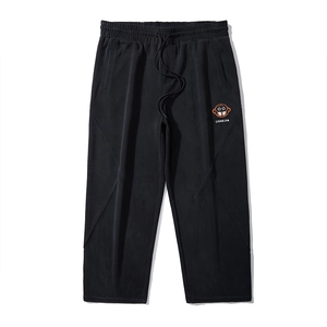 Men's black joggers with orange cartoon monkey print and stylish X-shaped stitch design