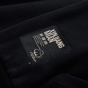 Black cotton hoodie featuring detailed embroidered Xinjiang Cotton woven patch label