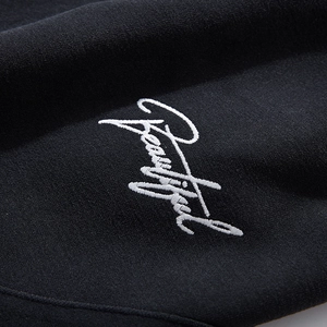 Fashion hoodie with high-quality white embroidery of the word Beautiful on black fabric