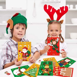 Kids playing with DIY Christmas stickers featuring Santa, snowmen, and reindeer on a table
