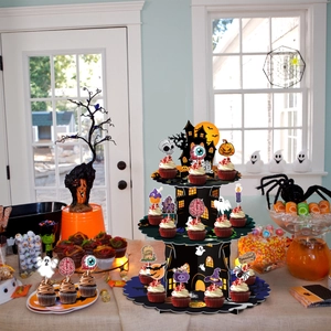 3-tier Halloween cardboard cupcake stand with castle illustrations and various toppers