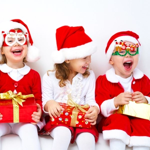 Kids wearing festive Christmas party paper glasses with Santa Claus and HO HO HO designs