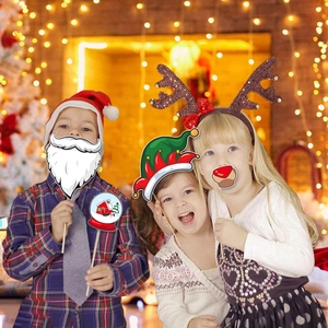 Three children using reindeer headband and Santa props in festive Christmas setting