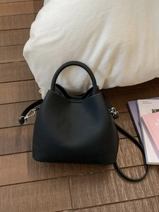 Minimalist black bucket handbag with round handle and detachable silver metal strap hook