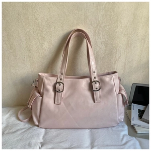 Detail of light pink tote bag with adjustable silver buckles and side flap pockets