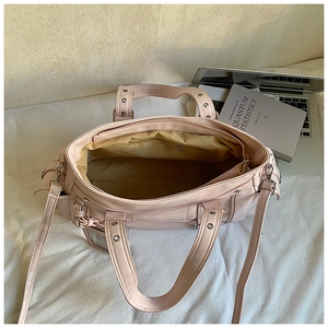 Detailed interior of pink tote bag showing spacious main compartment and zip pocket