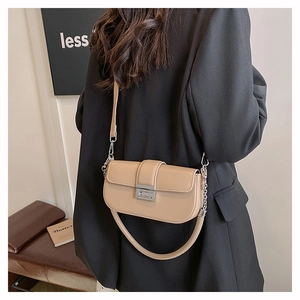 Fashionable beige faux leather baguette bag shown with detachable strap and metal lock