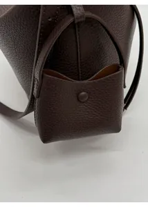 Detail of dark brown pebble leather tote bag with a matching mini snap-button pouch