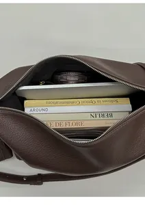 Top view of deep brown leather tote bag interior showing large capacity for daily items