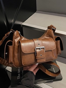 Retro brown multi-pocket crossbody bag with silver buckles and a wide shoulder strap