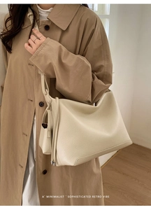 Detail of cream-white pebble grain leather hobo bag with minimalist vintage aesthetic