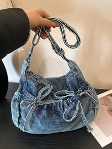 Retro washed denim bucket bag with pleated drawstring and decorative butterfly bows