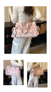 Detailed close-up of pink oversized hobo bag with zip accents and textured finish