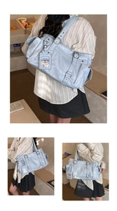Detail view of light blue retro tote bag with multi-pocket design and cute charm