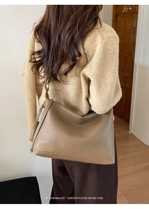 Detailed view of grey-brown retro tote bag with lychee grain texture shown on shoulder