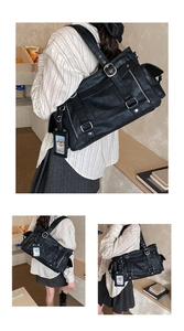 Macro view of vintage matte leather tote with silver metal buckles and decorative straps