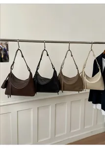 Detail view of large soft leather hobo bags in dark brown, black, coffee, and beige colors