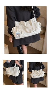 Close-up of white PU tote bag showing silver zippers and transparent card slot detail