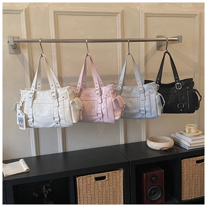 Retro shoulder bags in white, pink, blue, and black with utility pockets and metal studs