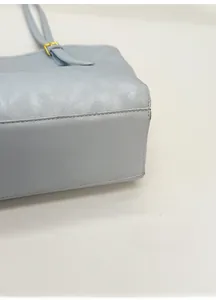 Detail of light blue tote bag showing reinforced bottom structure and fine stitching