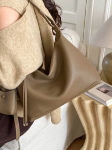 Brown litchi leather hobo bag with drawstring detail, soft vintage tote style for women
