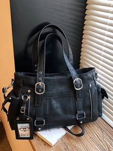Retro black faux leather motor-style tote bag with decorative metal buckles and multiple pockets
