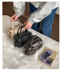 Detailed close-up of Boston style leather handbags with star rivets and heart charms
