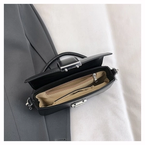 Interior layout of the black crossbody bag showing organized compartments and silver zippers