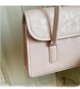 Close-up of soft lychee texture and fine stitching on pink large shoulder bag