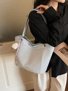 Light blue faux suede tote bag with double shoulder straps and woven ice cream pendant