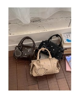 Boston bags in dark brown, black, and beige with star studs and heart charms