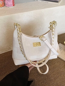 Chic beige jacquard underarm bag with gold chain and swivel lock on stone surface