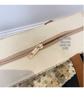 Detail of high-quality smooth metal zipper and canvas closure on woven straw tote bag