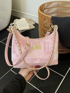 Pink patchwork hobo shoulder bag with gold chain strap and metallic twist-lock closure